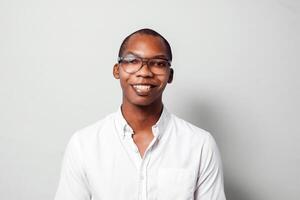 Portrait of cheerful business black young man entrepreneur look at camera over gray background. photo