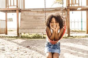 portrait of a smiling afro american girl look at camera. childhood and happiness concept. photo