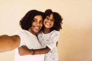 portrait of mother and daughter taking a selfie. photo
