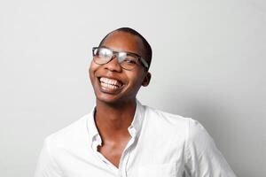 Head shot of a cheerful black man happy with glasses look at camera. photo
