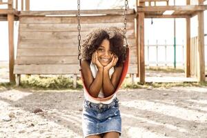 portrait of a smiling afro american girl look at camera. childhood and happiness concept. photo