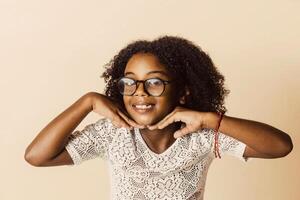 Portrait of happy Afro American girl look at the camera. Fun Cheerful smiling child wearing glasses. photo