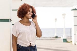 happy afro american woman make a phone call. communication concept. photo