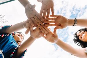Group of women with their hands together. photo