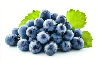Fresh blue grapes arranged with green leaves on a light background ready for consumption photo