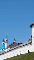 Mosque on a sunny summer day surrounded by high wall and a tower on blue cloudy sky background. Stock footage. Religion concept, Mosque and the fortress. video