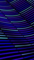 3D abstract curved background with moving neon lines. Animation. Looped background with wave stream of short neon lines on black background video