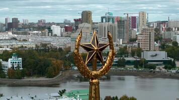 Aerial view of a building top, historical element of a roof. Stock footage. Golden spire with USSR star on the background of a city. video