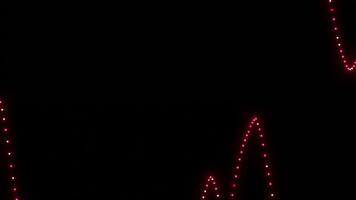 Black background. Design. Pink swaying beads in animation that scatter in different directions. video