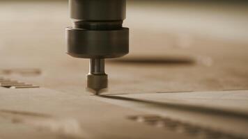 Close-up drilling of pattern on wood. Creative. Thin wood carving machine. Machine drills on wood with whirlwind of dust video