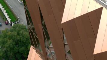 Aerial view of details of a new skyscraper of bronze color. Stock footage. Modern architecture of the business city district. video