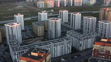 Top view of modern residential complex with sunlight. Stock footage. Beautiful red rays of sun fall on residential complex. Residential urban complex in modern area of city video
