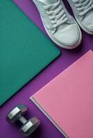 Bright workout space featuring pastel weights and sneakers on exercise mats photo