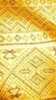 Golden fabric background with east pattern. Oriental Indian cloth background with golden floral pattern video