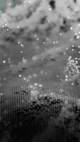 Background of moving monochrome abstract particles. Monochromatic abstract background with bokeh objects. Real falling particles video