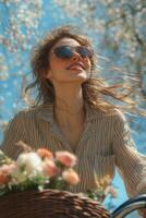 A joyful woman riding a bicycle with a floral basket on a sunny day in the park photo