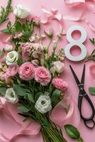 Pink floral arrangement with ribbon and the number eight on a pastel pink background photo