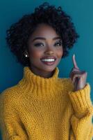 Young woman in bright sweater gestures playfully against a vibrant blue background photo