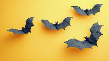 Bats flying against a vibrant yellow backdrop during Halloween-themed decorations photo