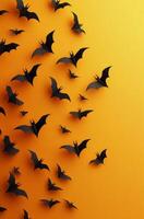 A collection of paper bats flying against a bright orange background during autumn season photo