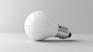 White light bulb resting on a smooth surface in a minimalist setting with soft lighting photo