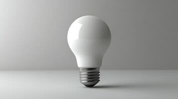 White light bulb resting on a smooth surface in a minimalist setting with soft lighting photo