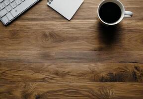A cozy workspace with a cup of coffee, laptop, and notepad on a wooden table in the morning photo