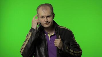 You are crazy, out of mind. Annoyed man pointing at camera and showing stupid gesture, blaming idiot video