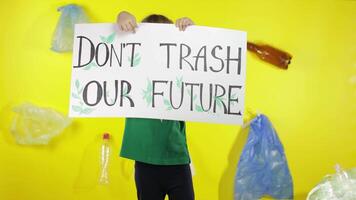 Girl activist holding poster Don't Trash Our Future. Reduce nature pollution. Save environment video