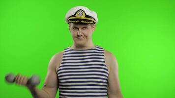 Sailor man making weightlifting with dumbbells. Seaman guy in sailor's vest video