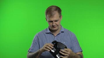 Man using VR headset helmet to play game. Watching virtual reality 3d 360 . Chroma key video