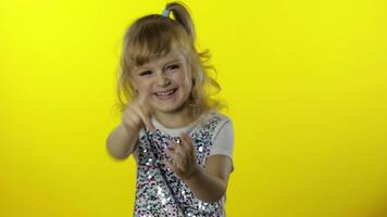 Happy child pointing finger at camera and laughing out loud with tears, making fun of funny joke video