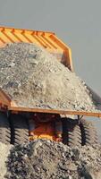 Mining loader unloads limestone ore or rock. View from the back. video
