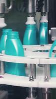 Liquid detergent on automated production line. Clip. Automated production line of washing fluid. Machinery for bottling video