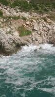 The waves breaking on a stony beach, forming a spray. Footage. Splashing waves on the rocks of the sea video