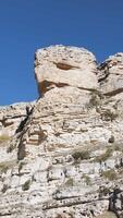 Low angle view of rock formations against clear blue sky. White giant mountains on a summer day. video