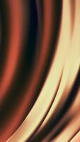 Abstract golden silky waves flowing slowly and shimmering on black background. Animation. Orange and yellow soft bow shaped stripes moving in sun flares. video