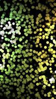 Abstract animation of small colorful particles chaotically moving on the black background and changing a color. Animation. Dynamic colorful animation on the black background video