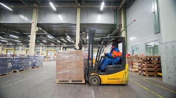 Serbia - Belgrade, September 20, 2022. Packing and assembly of goods. Creative. View of a large warehouse with large packed boxes that are assembled by workers on special small machines. video