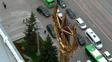 Soviet symbol, golden spire on the background of a street with moving cars. Stock footage. Golden star and ears of wheat. video