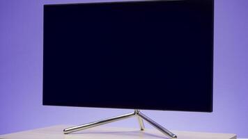 Large plasma TV. Action. A blue background with a changing color with a new generation TV that is shot from all angles. video