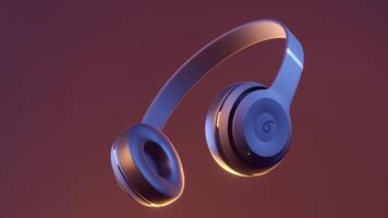 Abstract rotating headphones. Design. Beats Electronics, monster beats new headphones isolated on a colorful background. For editorial use only. video
