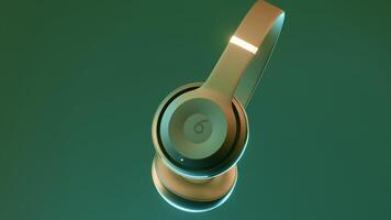 Gray and green background. Design.The concept of new gadgets.Wireless headphones rotate around themselves in animation. video