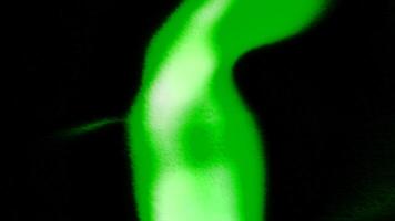 Black background with green and purple light in animation and. Motion. A walking bright lantern dissolving in different directions. video