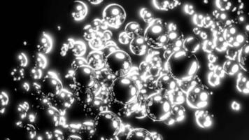 Abstract stream of metallic bubbles on a black background. Design. Flowing glowing spheres. video