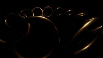Dark background. Design. Gold large rings that rotate in a circle made in computer graphics. video