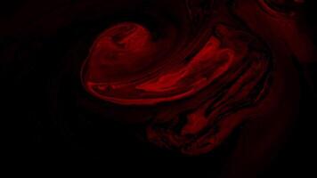 Dark background. Motion. Red dense volumetric slurry spreads over a black background in animation. video
