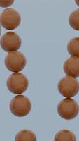 Close up of wooden brown sphere falling inside the falling apart figure of small balls. Design. Shape of balls destructing with a moving reverse effect. video