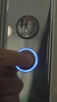 Mans hand pressing elevator down button. HDR. Close up of male finger getting the elevator by pushing the silver metal button. video