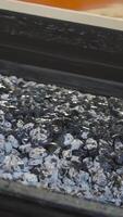 Pile of coal moves on belt conveyor at factory. Stock footage. Processing of raw materials or coal at plant. Conveyor for moving mass of raw materials during processing video